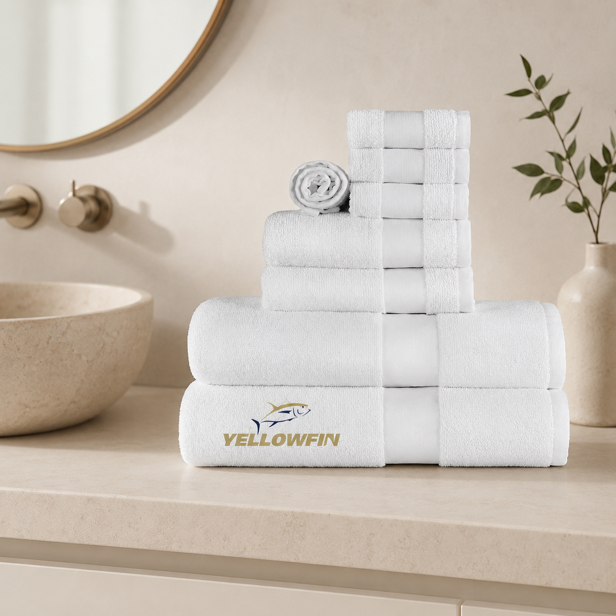 Stack of white towels with Yellowfin logo on a bathroom counter