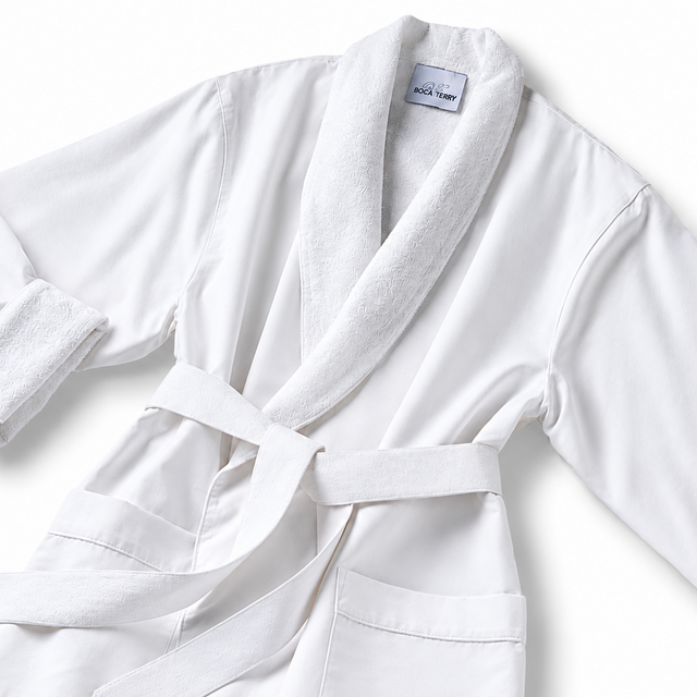 Pictured: White spa robe against a white background. This robe is the Microfiber Classic Shawl Collar Bathrobe. The inside of the robe and the collar are a fluffier material for maximum comfort.