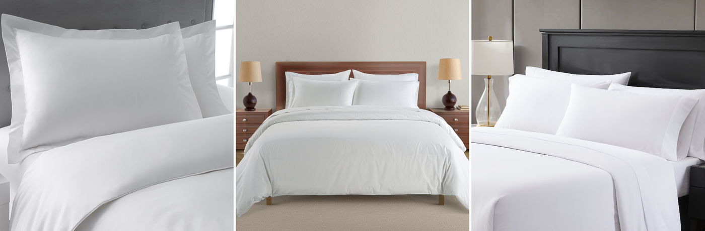 White bedding set on a bed with nightstands and lamps in a bedroom setting.