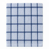 Pictured: Folded white towel with muted blue accents in a windowpane design against a white background. This product is listed as "Blue/Chambray".