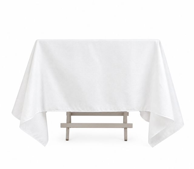 Pictured: Eye level front shot of the white Dynasty Tablecloth draped over a table against a white background.