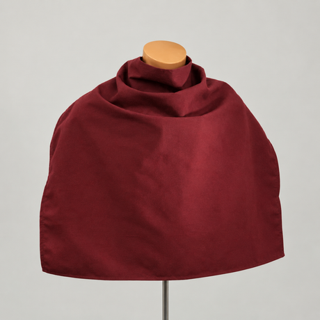 Pictured: Large red bib draped over a headless mannequin. This bib is in the shade "Burgundy". The bib goes around the neck and is meant to protect clothing from food, drink, etc.