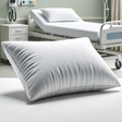 Pictured: Gray and Rectangular Disposable Hospital Pillow sitting up with a hospital room background.