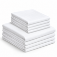 Pictured: Neatly folded white Economy Sheets stacked on top of each other. There are 4 larger sheets on the bottom and 4 smaller sheets stacked on top.