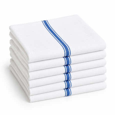 Pictured: Neatly folded stack of the Economy Kitchen Towels in the center against white background. The towels are white with a thick blue stripe and two thin blue stripes on either side down the middle.
