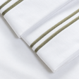 Pictured: Extreme close-up of the embroidery on these white sheets. 