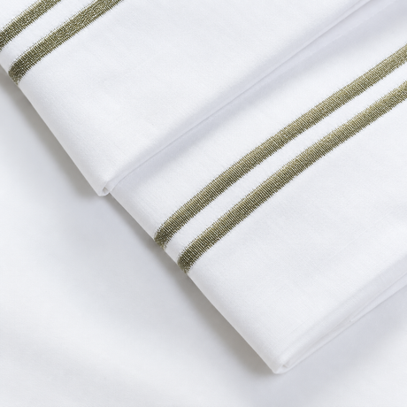 Pictured: Extreme close-up of the embroidery on these white sheets. 