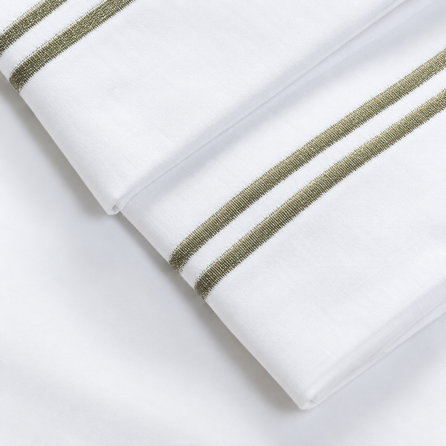 Pictured: Extreme close-up of the embroidery on these white sheets. 