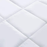 Close-up of a white quilted fabric with diamond pattern