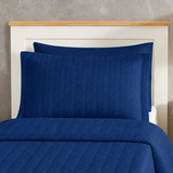 Pictured: Close-up of the Flourish Quilt Pillow Sham in the shade Sail Blue.