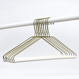 Pictured: 8 Golden hangers with rounded hook and white cardboard tube hanging on a rod against a white background.