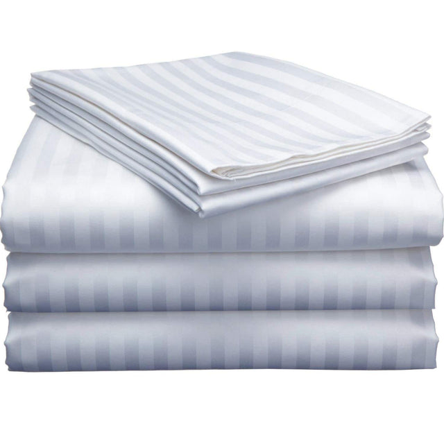 Pictured: Neatly folded stack of white Magnificence T-310 sheets against a white background. The sheets have a satin finish and are striped.