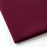 Pictured: Close-up of a neatly folded tablecloth against a white background. This tablecloth is in the shade Maroon.