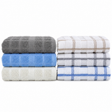 Pictured: Two neatly folded stacks of several dishcloths in multiple styles and colors against a white background. The styles on the left from top to bottom are; Solid Grey, Solid Blue and Solid Khaki. The styles on the right from top to bottom are; Khaki Windowpane, Grey Windowpane and Blue windowpane.