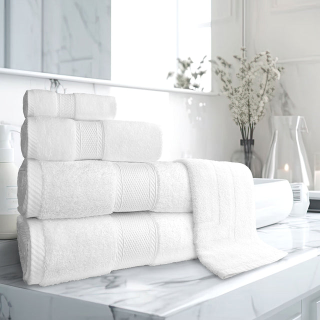 Stack of white towels on a marble surface with a blurred indoor background