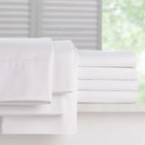 Pictured: Full Millennium t-200 Sheets, neatly folded and stacked atop a white counter in front of a window. The items you can get are the fitted sheet, the flat sheet and the pillowcases.