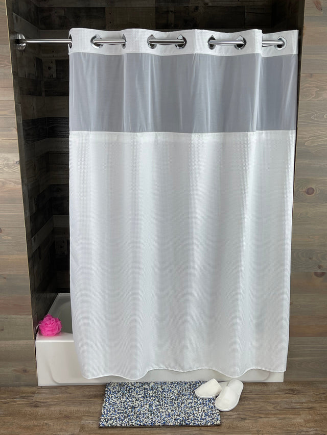 White roller blind on a wooden window frame with a textured wall background