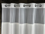White shower curtain with silver rings on a dark background