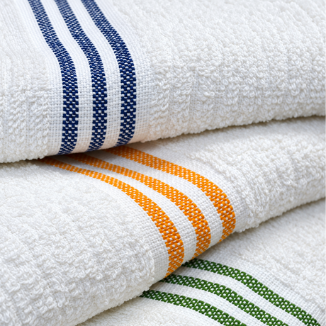 Pictured: Extreme closeup of three white towels with 3 colored stripes on the borders. The colors from top to bottom are Blue, Gold and Green.