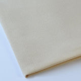 Pictured: Close up of the Premier Napkin neatly folded in the shade Beige against a white background.