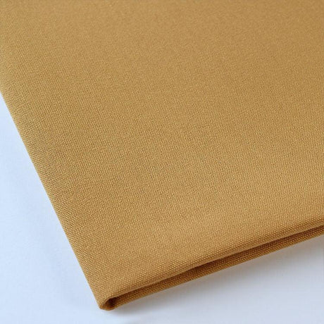 Pictured: Close up of the Premier Napkin neatly folded in the shade Bronze against a white background.