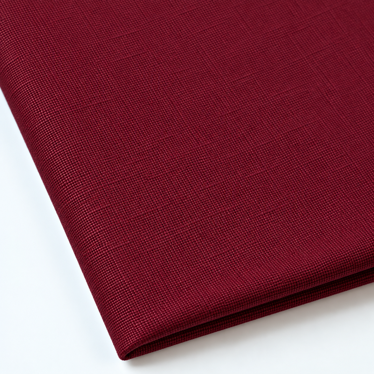 Pictured: Close up of the Premier Napkin neatly folded in the shade Burgundy against a white background.