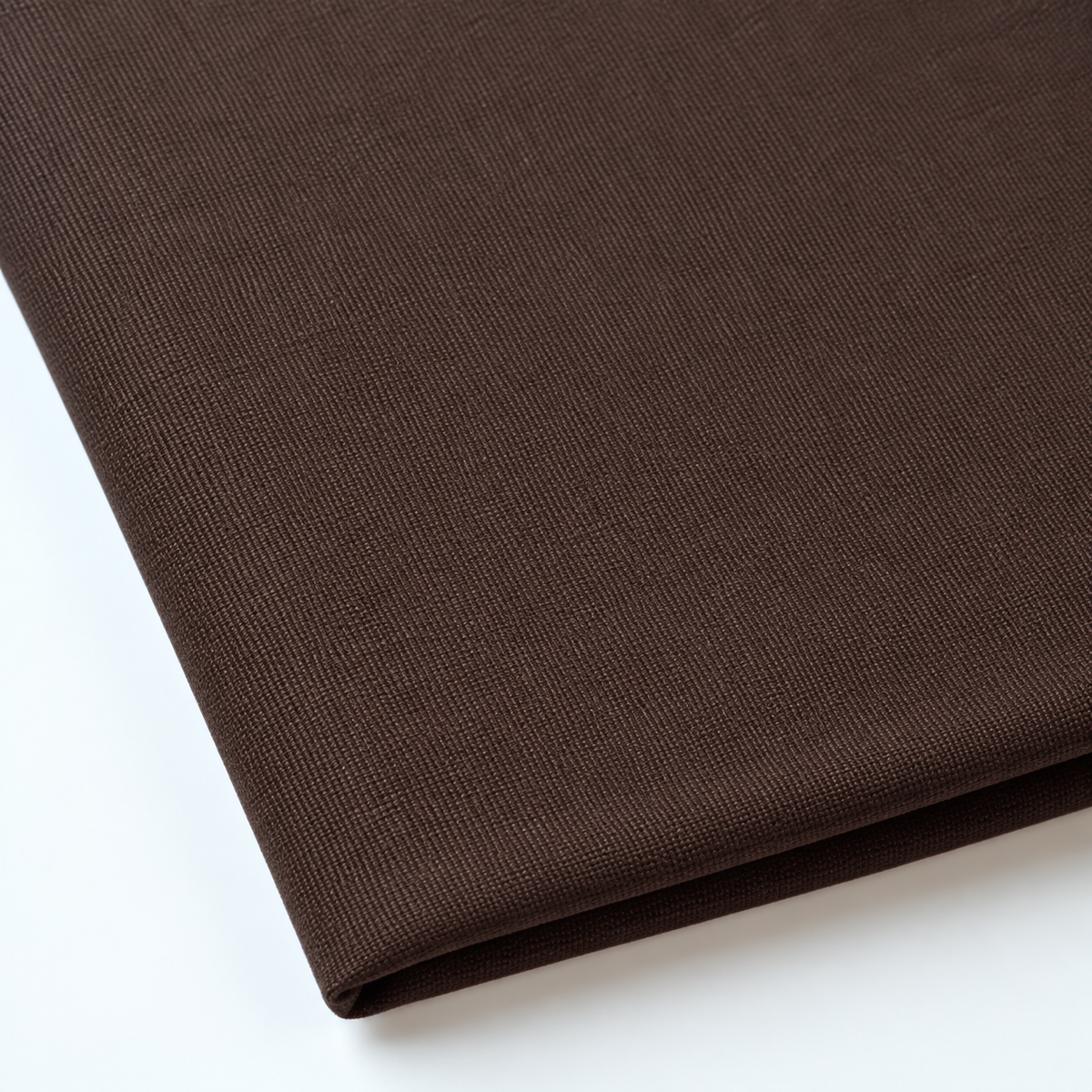 Pictured: Close up of the Premier Napkin neatly folded in the shade Chocolate against a white background.