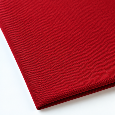 Pictured: Close up of the Premier Napkin neatly folded in the shade Flag Red against a white background.