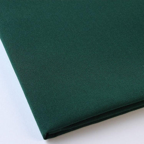 Pictured: Close up of the Premier Napkin neatly folded in the shade Forest Green against a white background.