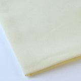 Pictured: Close up of the Premier Napkin neatly folded in the shade Ivory against a white background.