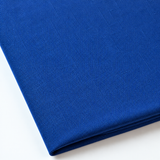 Pictured: Close up of the Premier Napkin neatly folded in the shade Royal Blue against a white background.
