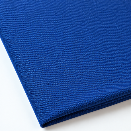 Pictured: Close up of the Premier Napkin neatly folded in the shade Royal Blue against a white background.