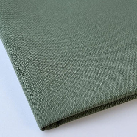 Pictured: Close up of the Premier Napkin neatly folded in the shade Sage against a white background.