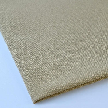 Pictured: Close up of the Premier Napkin neatly folded in the shade Sandalwood against a white background.