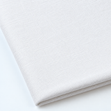 Pictured: Close up of the Premier Napkin neatly folded in the shade White against a white background.