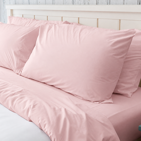 Pictured: Rose bedding on a white bed frame. The blanket is white, and has a rose top sheet, fitted sheet and pillowcases.