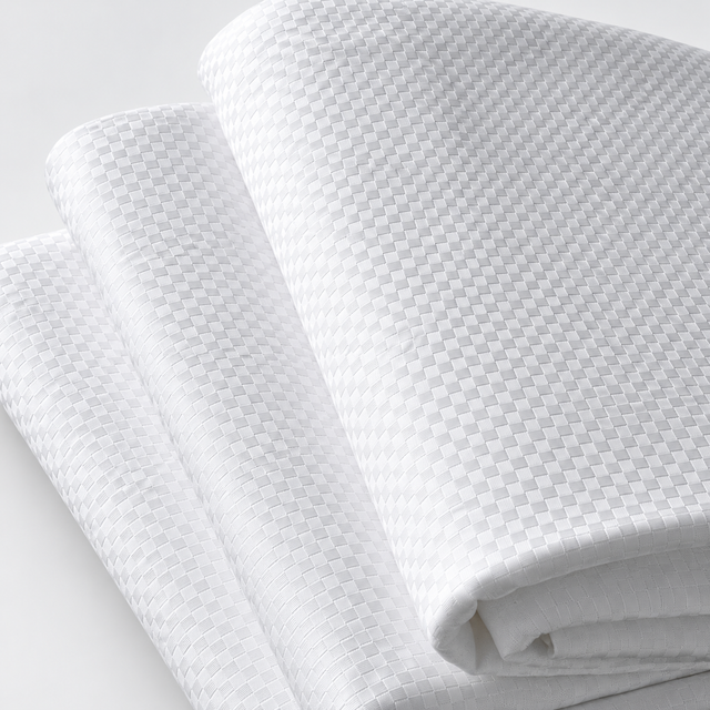Pictured: Three white checkered sheets neatly folded and stacked on top of each other against a white background.