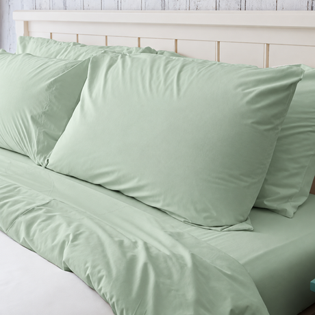 Pictured: Seafoam Green bedding on a white bed frame. The blanket is white, and has a Seafoam Green top sheet, fitted sheet and pillowcases.
