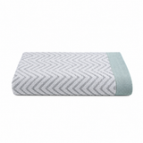 Pictured: Folded Fibertone Chevron Jacquard Pool Towel against a white background. This towel is in the shade "Seafoam".