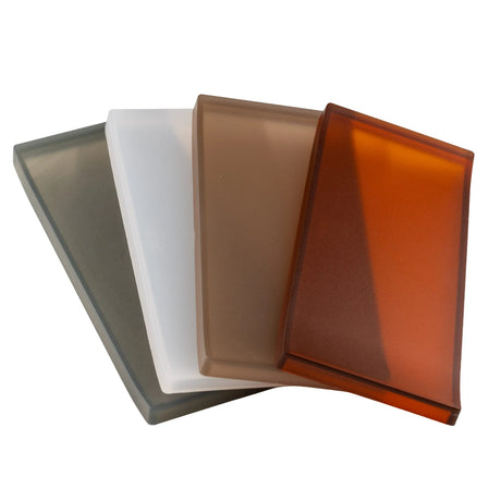 Pictured: Rectangular amenity trays  of multiple colors spread out together against a white background. The colors from left to right are: Smoke, Frost, Fawn and Amber.