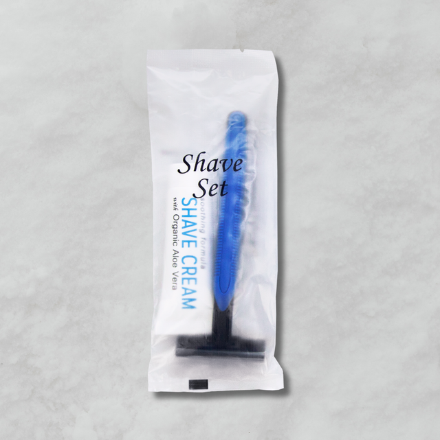 Pictured: Shave set in a white and transparent packet. Through the plastic you can see the razor and shaving cream that comes in the set.