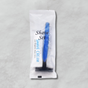 Pictured: Shave set in a white and transparent packet. Through the plastic you can see the razor and shaving cream that comes in the set.