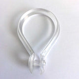 Pictured: Clear plastic teardrop shaped shower hook against a white background.