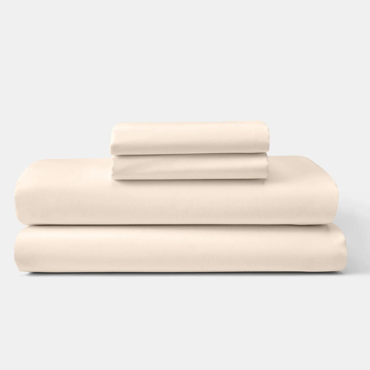 Pictured: Two large beige sheets neatly folded in a stack against a white background. There are also two smaller neatly folded beige sheets on top of the large stack.