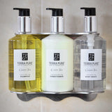 Pictured: The chrome tamper proof triple bracket holding products from the Terra Pure Green Tea line. The products from left to right are: the shampoo, conditioner and body wash.