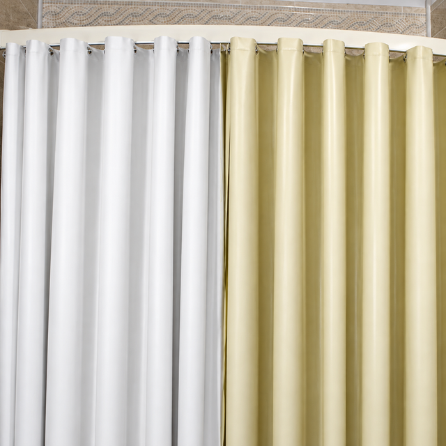 Pictured: Two curtains hanging side by side on a cream rod. The product featured is the Forester 8 Gauge Vinyl Shower Curtain in the shades White (left)  and Beige (right).