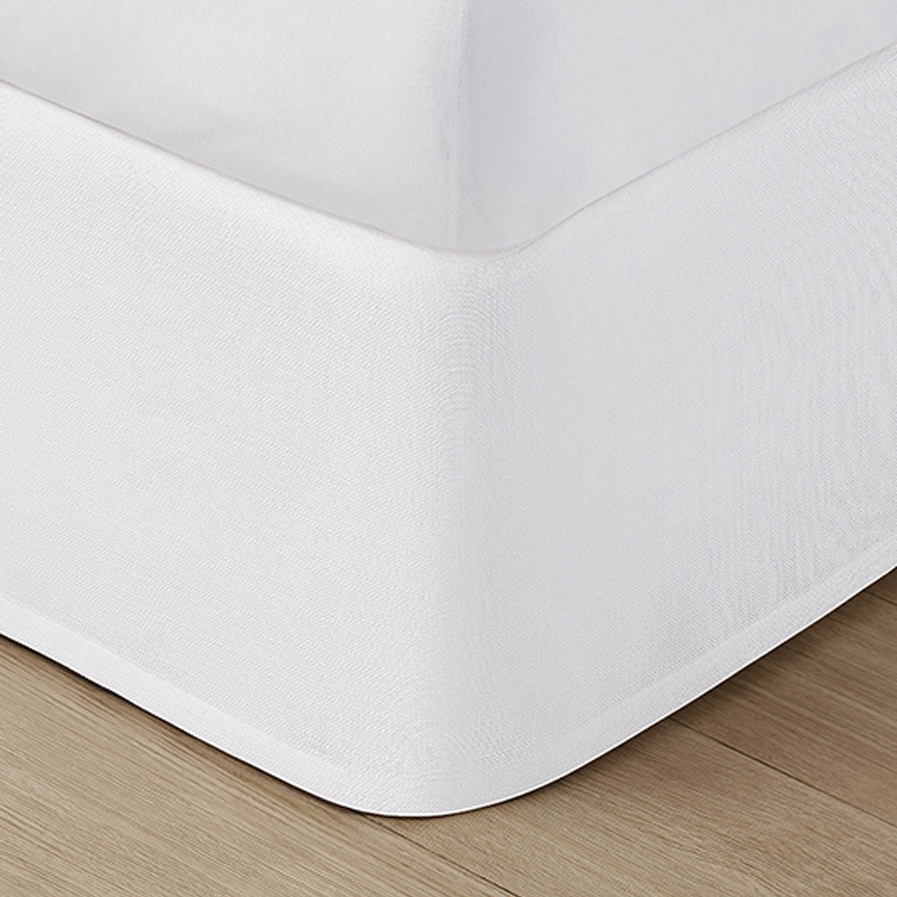 Pictured: White bed skirt under a white mattress.