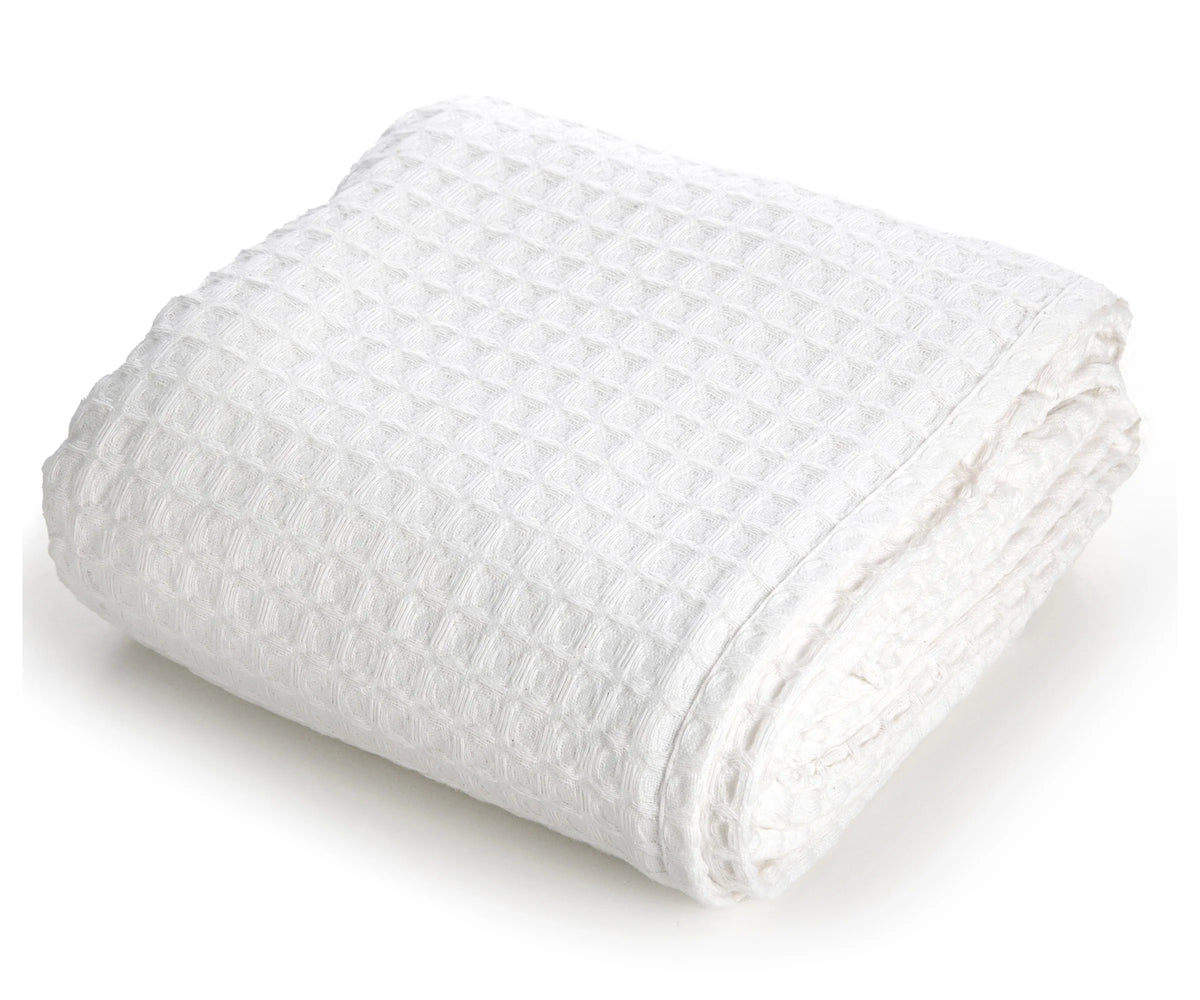Pictured: Neatly folded waffle woven blanket against a white background. This blanket is in the shade "White".