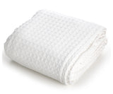 Pictured: Neatly folded waffle woven blanket against a white background. This blanket is in the shade "White".